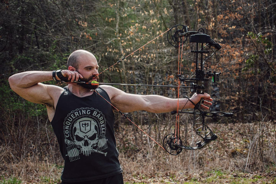 @paynterperiodization drawing a bow in a Conquering Barbell skull tank