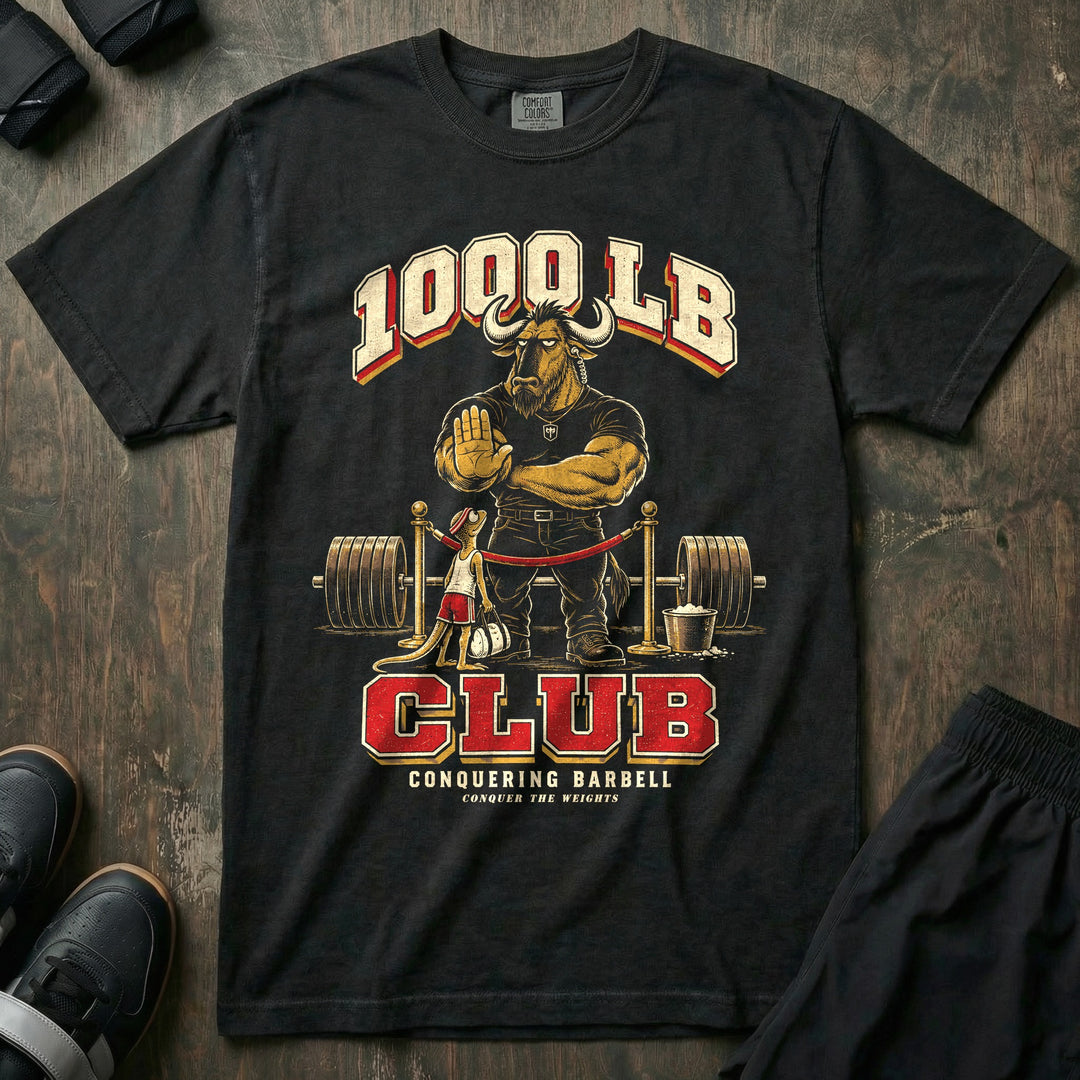 1000 LB Club - Relaxed Fit Tee front graphic in Black with a wildebeest bouncer holding up a hoof behind a velvet rope in front of a loaded barbell - Conquering Barbell