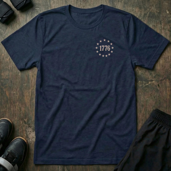 250 Years Strong tee: a distressed 1776 flag split alongside a barbell with a CB dog tag hanging from it