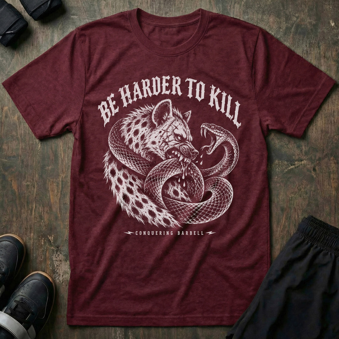 Be Harder to Kill Strike First tee in Maroon: a scarred hyena and a black mamba coiled around each other in full combat