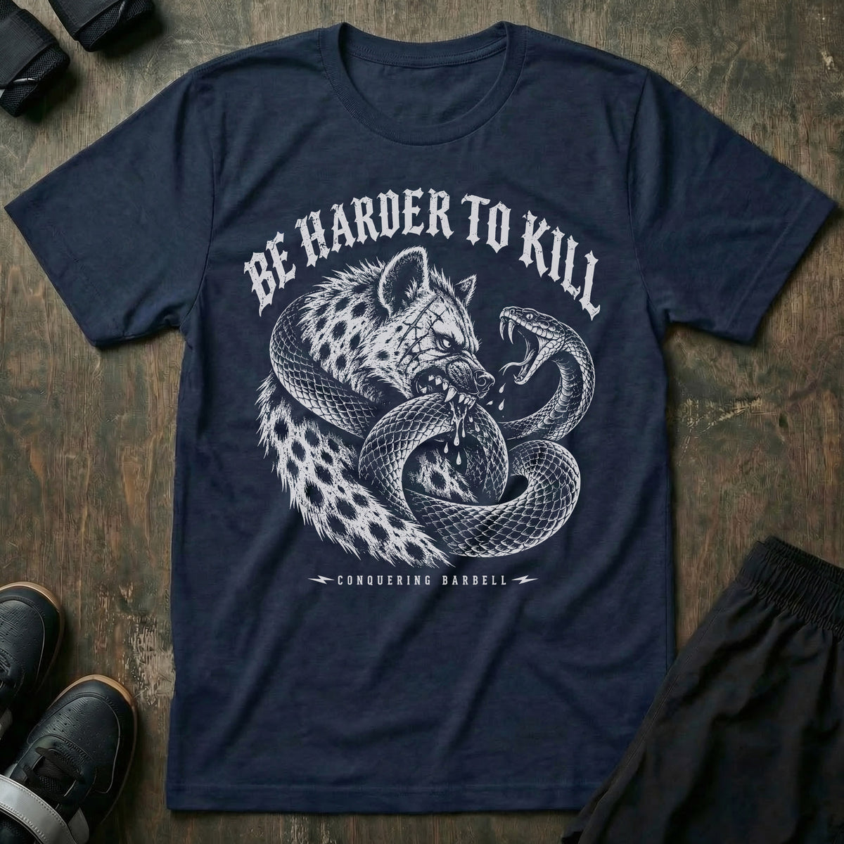 Be Harder to Kill Strike First tee in Navy: a scarred hyena and a black mamba coiled around each other in full combat