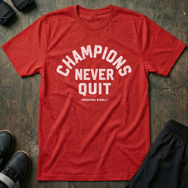 Champions Never Quit tee in Red: CHAMPIONS arched over NEVER QUIT in distressed varsity lettering