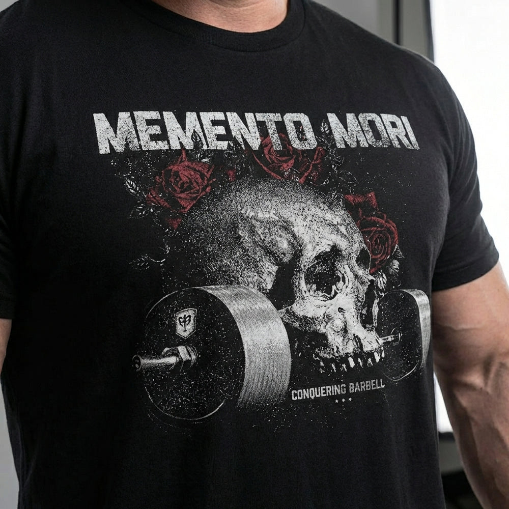 Memento Mori tee in Black: a grey skull with red roses resting on a loaded barbell