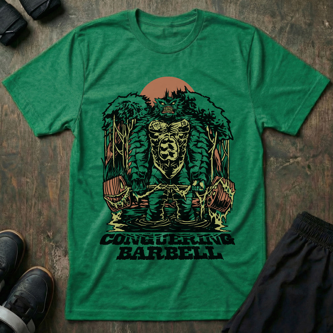 Swamp Monster tee in Kelly Green: a moss-covered swamp creature rising from the trees in front of a red sun