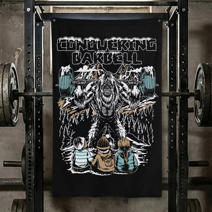 Yeti Squats Flag - Polyester Flag, vertical black gym flag with yeti squatting a loaded barbell among snowy peaks - Conquering Barbell