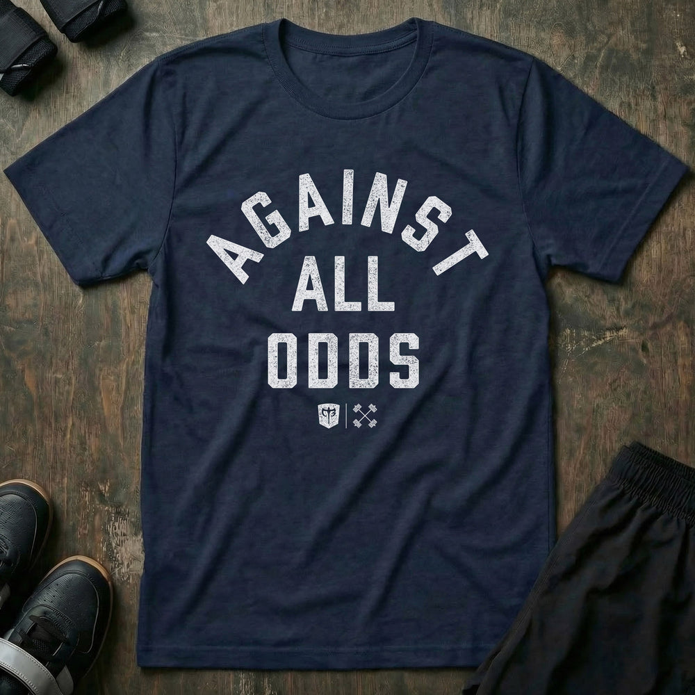 Against All Odds tee in Navy: AGAINST ALL ODDS in bold distressed collegiate lettering across the front