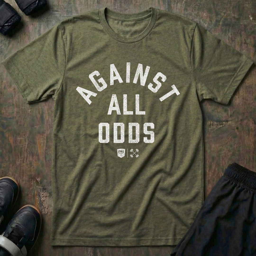 Against All Odds tee in Military: AGAINST ALL ODDS in bold distressed collegiate lettering across the front