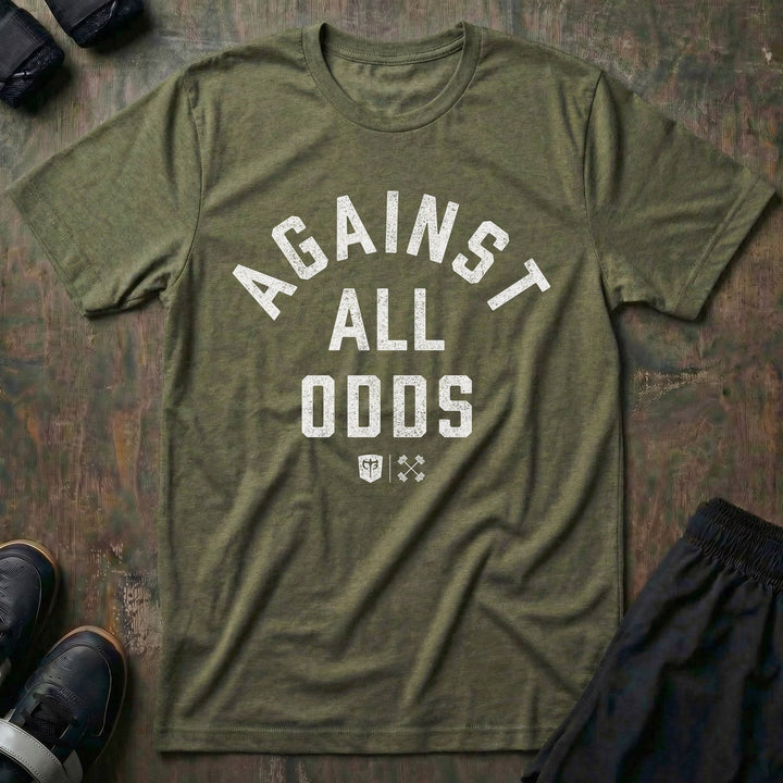 Against All Odds tee in Military: AGAINST ALL ODDS in bold distressed collegiate lettering across the front