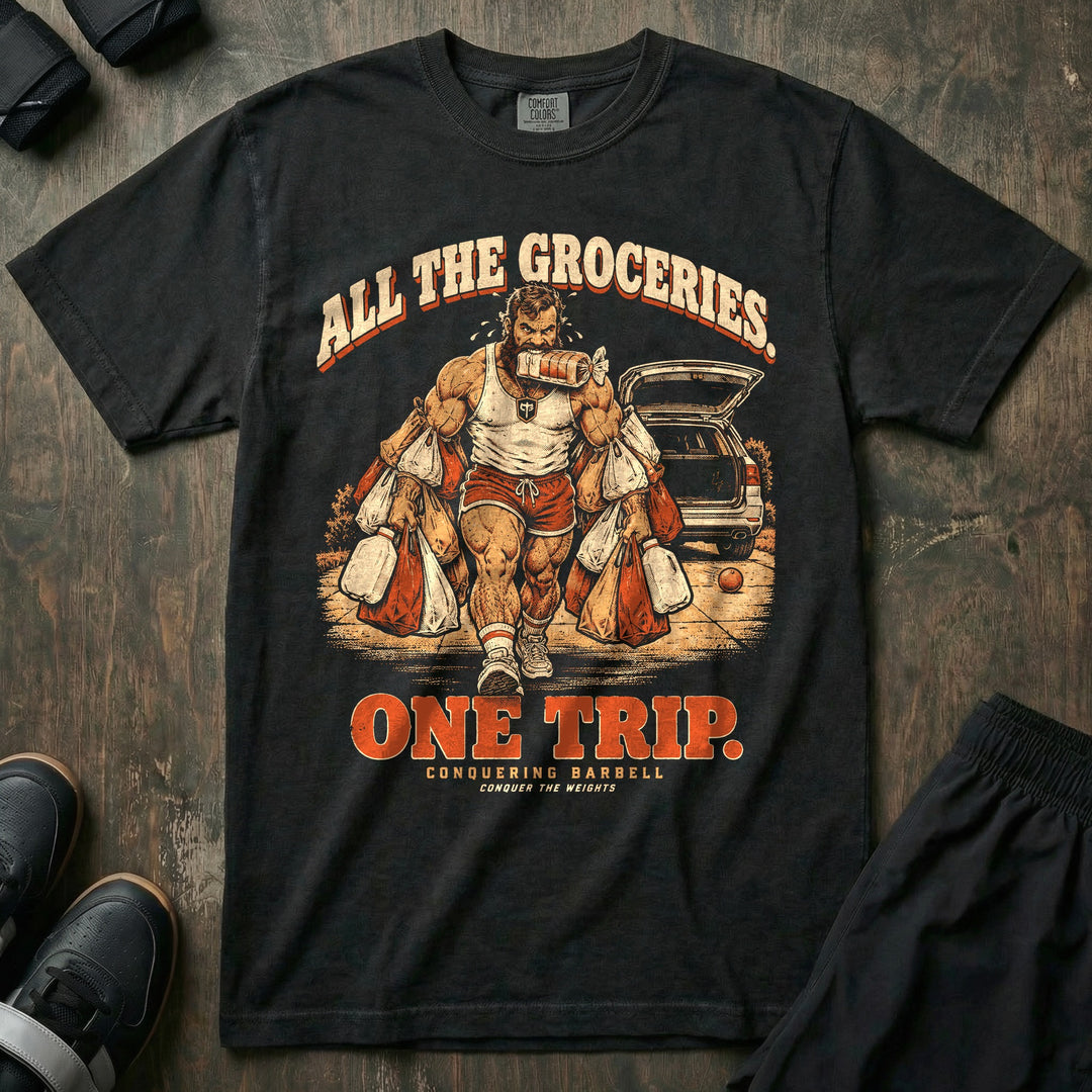 All the Groceries One Trip - Relaxed Fit Tee front graphic in Black with a bearded lifter carrying every grocery bag in one trip - Conquering Barbell