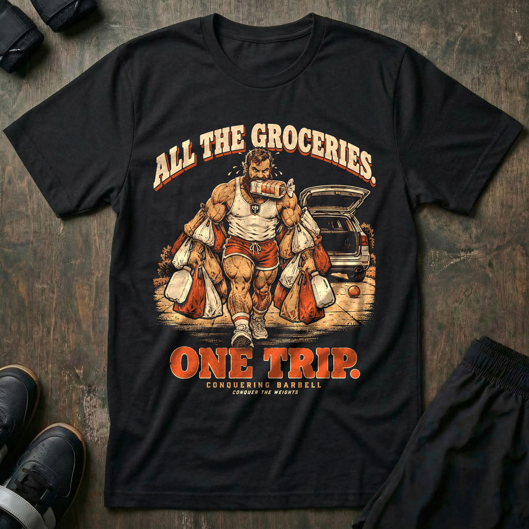All the Groceries One Trip - Tee front graphic in Black with a bearded lifter carrying every grocery bag in one trip - Conquering Barbell
