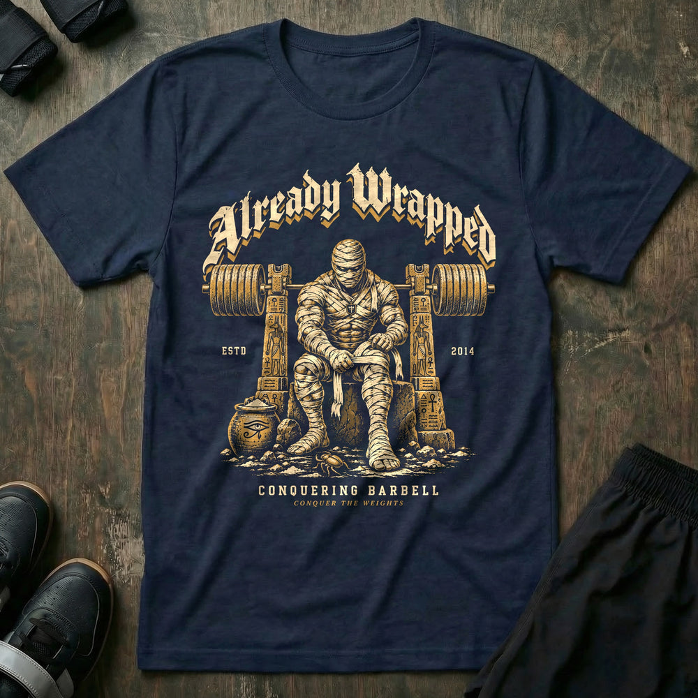 Already Wrapped - Tee front graphic in Navy with a mummy wrapping up under a loaded barbell - Conquering Barbell