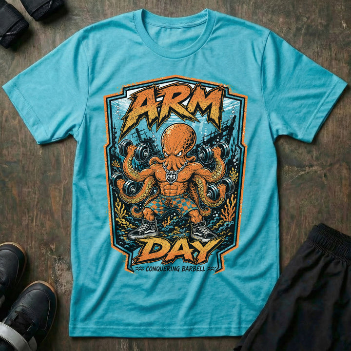 Arm Day Octopus tee in Tahiti: a jacked octopus in board shorts and skate shoes curling multiple dumbbells at once