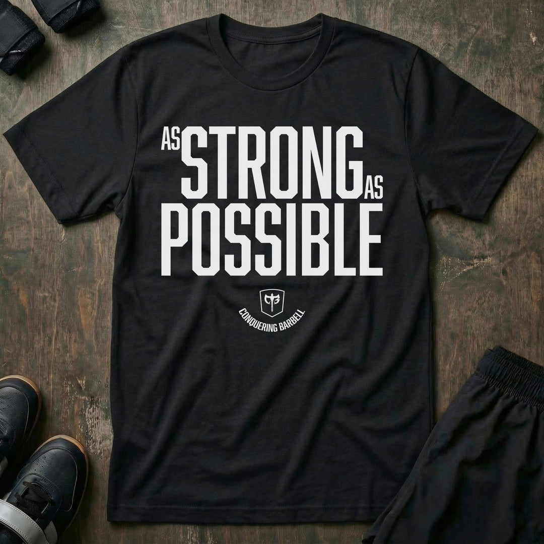 As Strong As Possible - on Black tee - Conquering Barbell