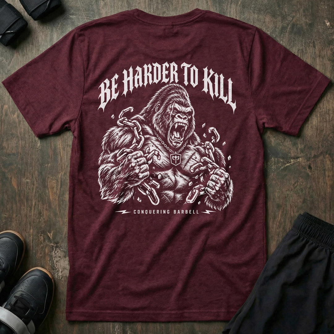 Be Harder to Kill Gorilla tee in Maroon: a massive silverback gorilla tearing heavy chains apart with both fists