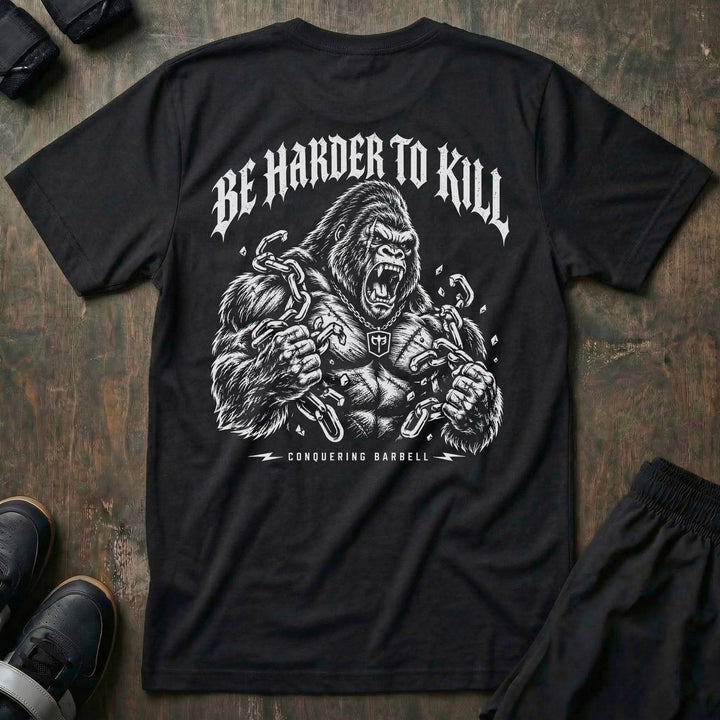 Be Harder to Kill Gorilla tee in Black: a massive silverback gorilla tearing heavy chains apart with both fists