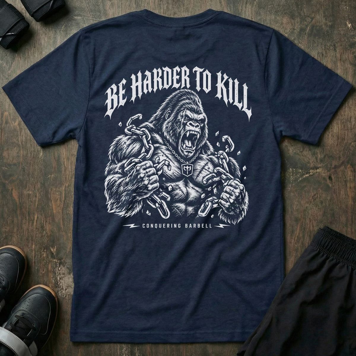 Be Harder to Kill Gorilla tee in Navy: a massive silverback gorilla tearing heavy chains apart with both fists
