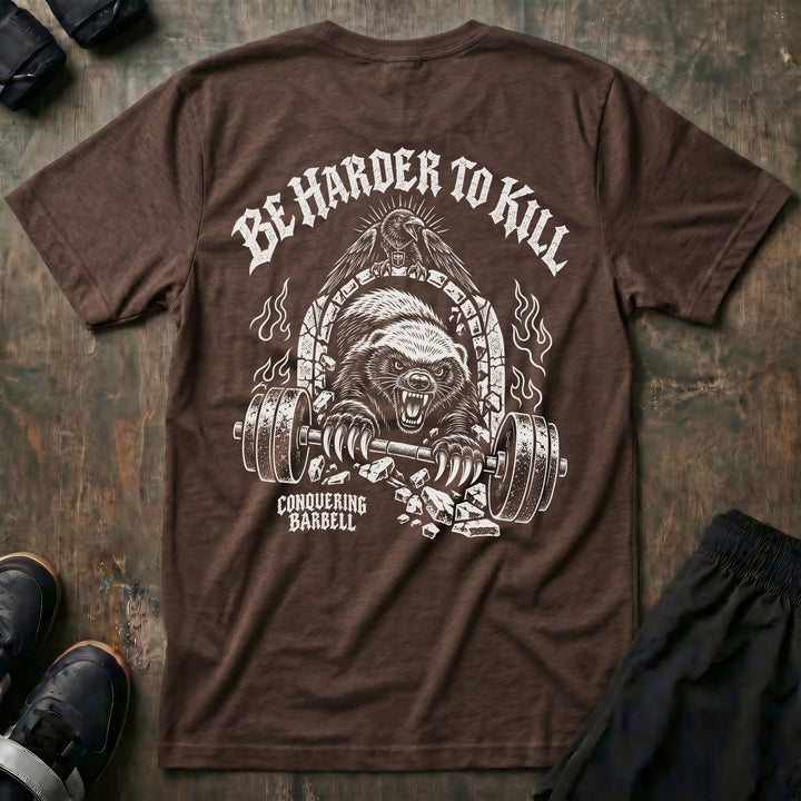 Be Harder to Kill Honey Badger tee in Expresso: a snarling honey badger bursting through a stone arch