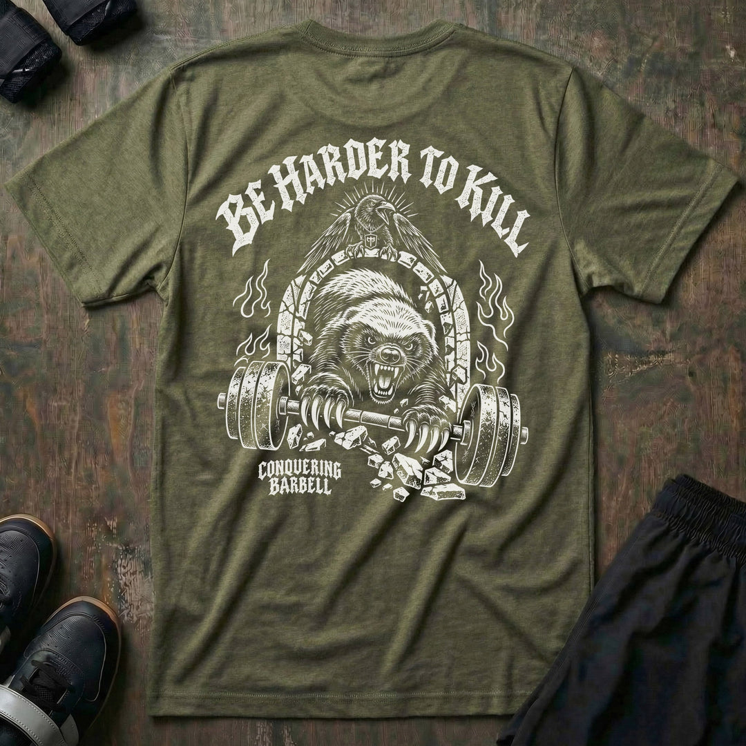 Be Harder to Kill Honey Badger tee in Military: a snarling honey badger bursting through a stone arch