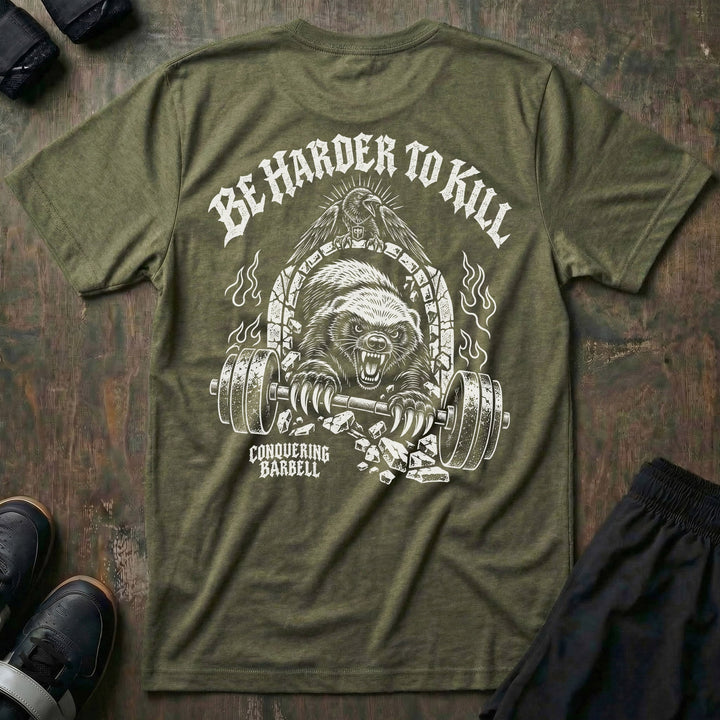 Be Harder to Kill Honey Badger tee in Military: a snarling honey badger bursting through a stone arch