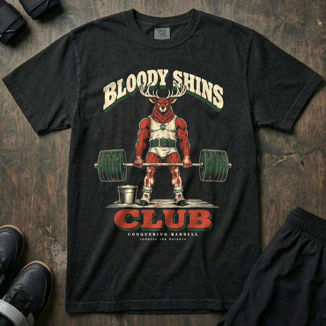 Bloody Shins Club - Relaxed Fit Tee front graphic in Black with a stag at deadlift lockout with scraped red shins - Conquering Barbell