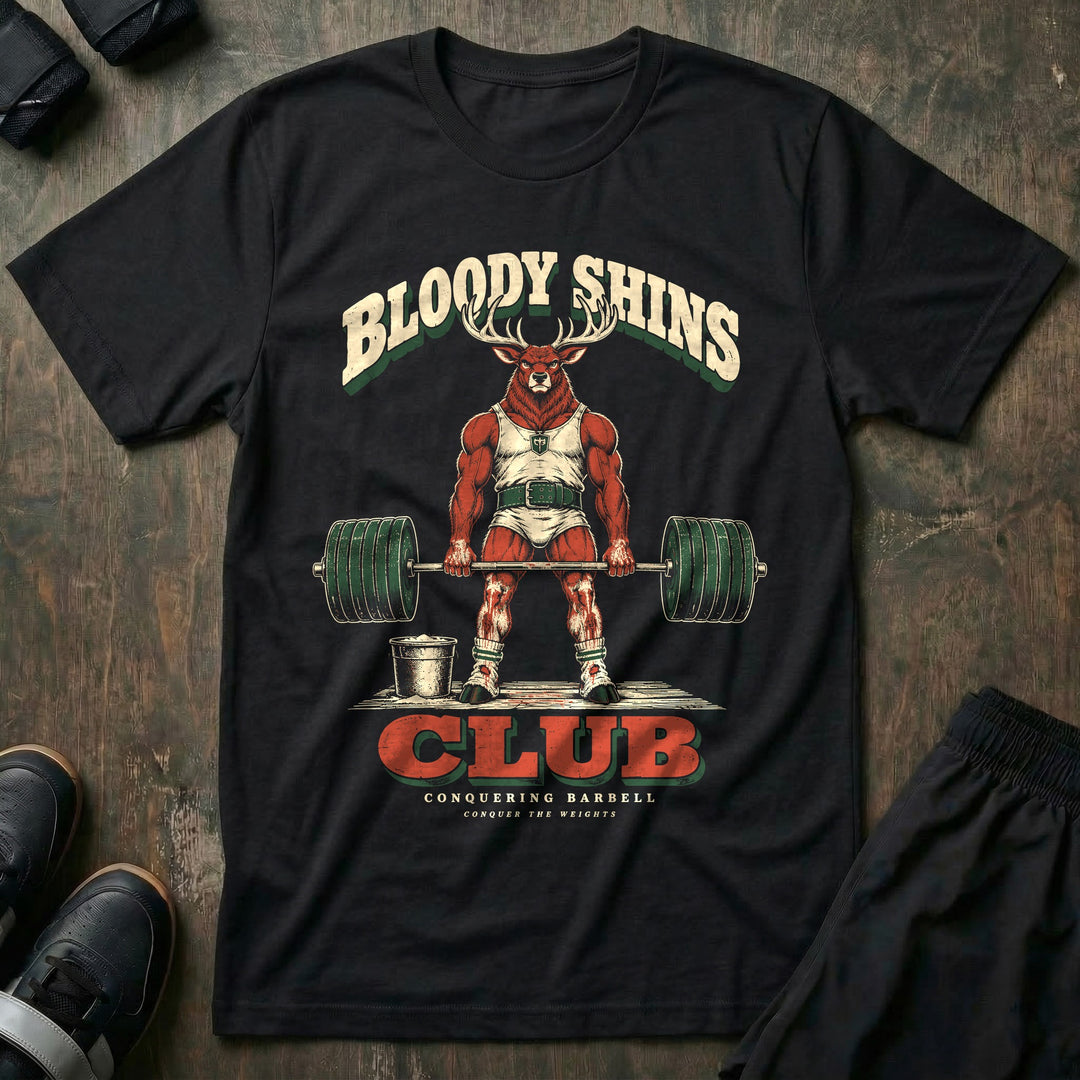 Bloody Shins Club - Tee front graphic in Black with a stag at deadlift lockout with scraped red shins - Conquering Barbell
