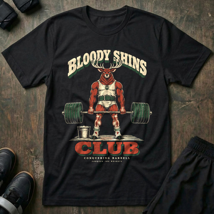 Bloody Shins Club - Tee front graphic in Black with a stag at deadlift lockout with scraped red shins - Conquering Barbell