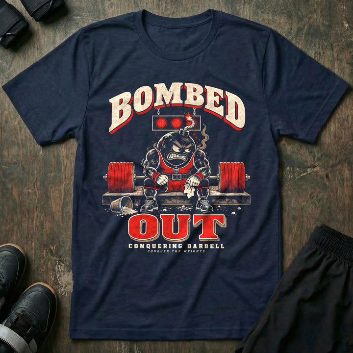 Bombed Out - Tee front graphic in Navy with a cartoon bomb mascot slumped on the lifting platform under red lights - Conquering Barbell
