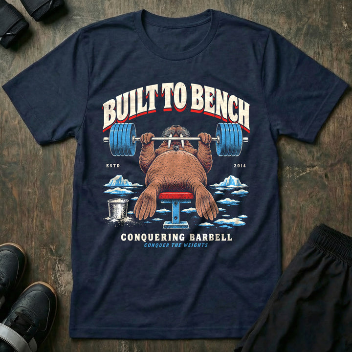 Built to Bench - Tee front graphic in Navy with a walrus bench pressing a loaded barbell on the ice - Conquering Barbell