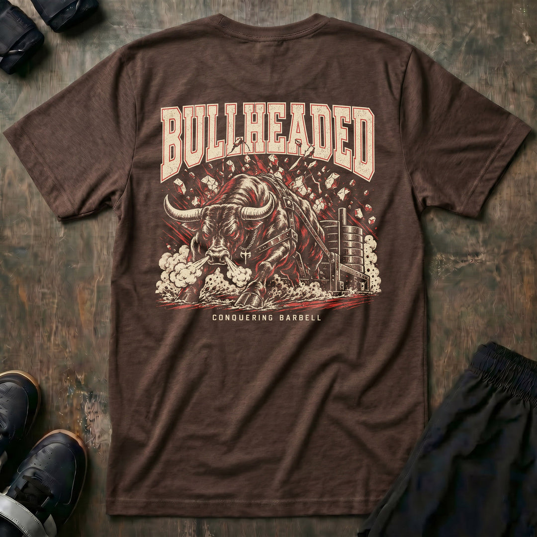 Bullheaded tee in Expresso: a raging bull breaking through a wall beside a loaded sled