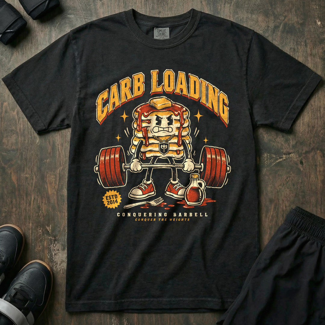 Carb Loading - Relaxed Fit Tee front graphic in Black with an angry pancake stack mascot deadlifting a loaded barbell - Conquering Barbell