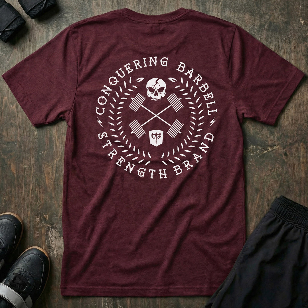 CB Badge Wreath tee in Maroon: a skull over crossed barbells inside a laurel wreath