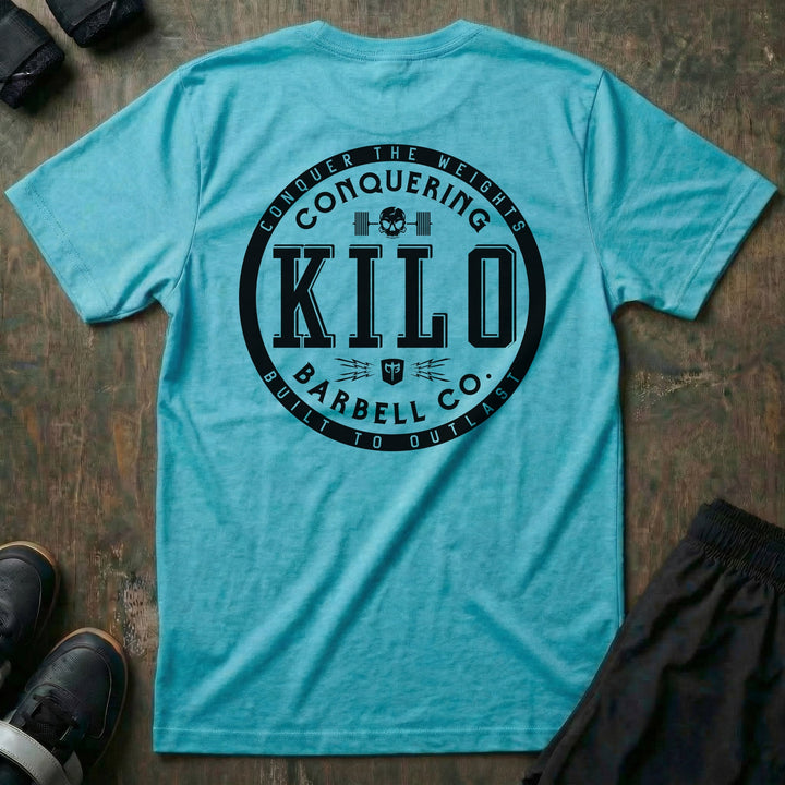 CB Kilo tee in Tahiti: a bold circular badge with block-letter KILO at the center