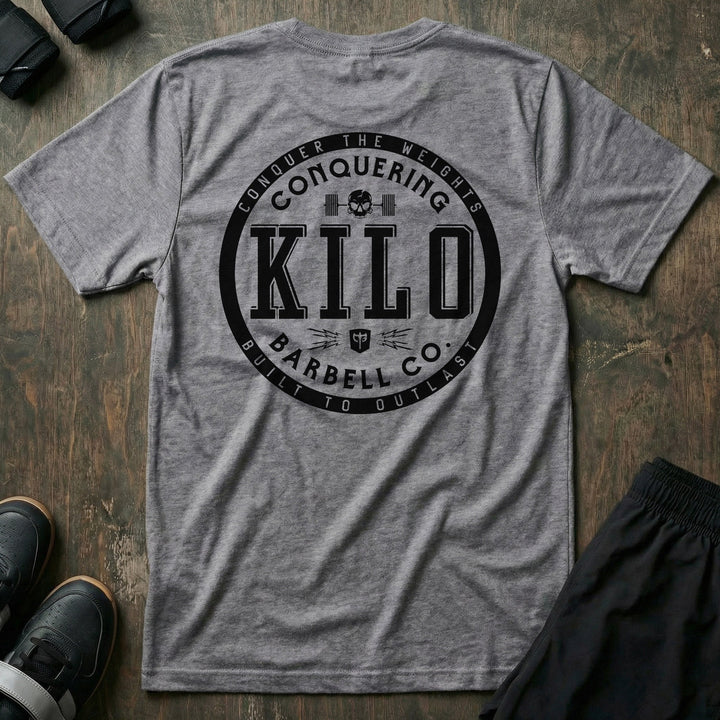 CB Kilo tee in Heather Grey: a bold circular badge with block-letter KILO at the center