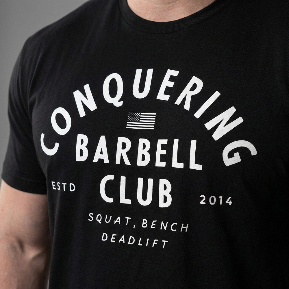 CB LIfting Club tee in Black: CONQUERING arched over an American flag