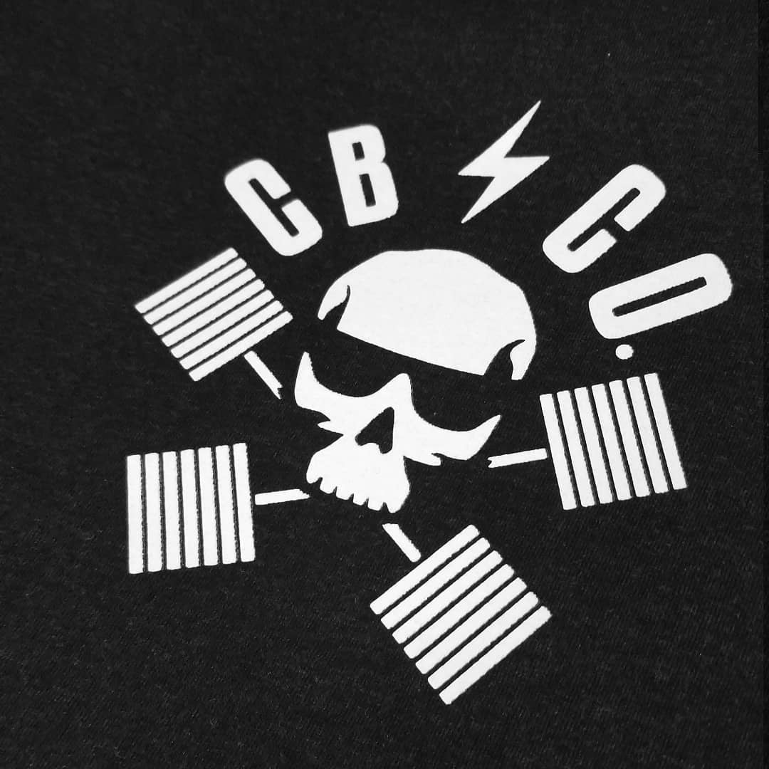 CB Pin-up tee in Black: a classic pin-up girl perched on a loaded barbell