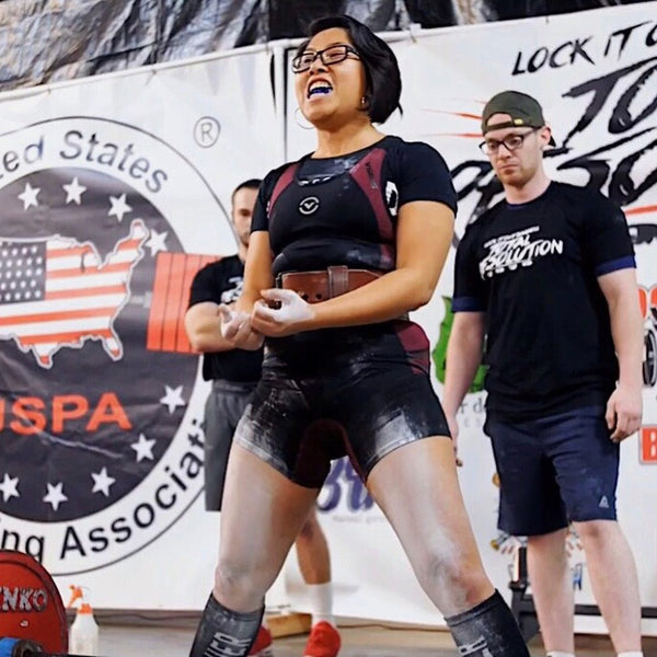 @_verothavirgo chalking up at a powerlifting meet