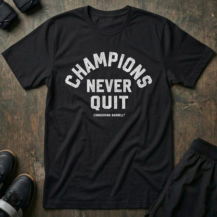 Champions Never Quit tee in Black: CHAMPIONS arched over NEVER QUIT in distressed varsity lettering