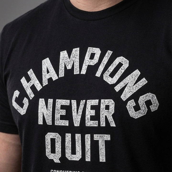 Champions Never Quit tee: CHAMPIONS arched over NEVER QUIT in distressed varsity lettering