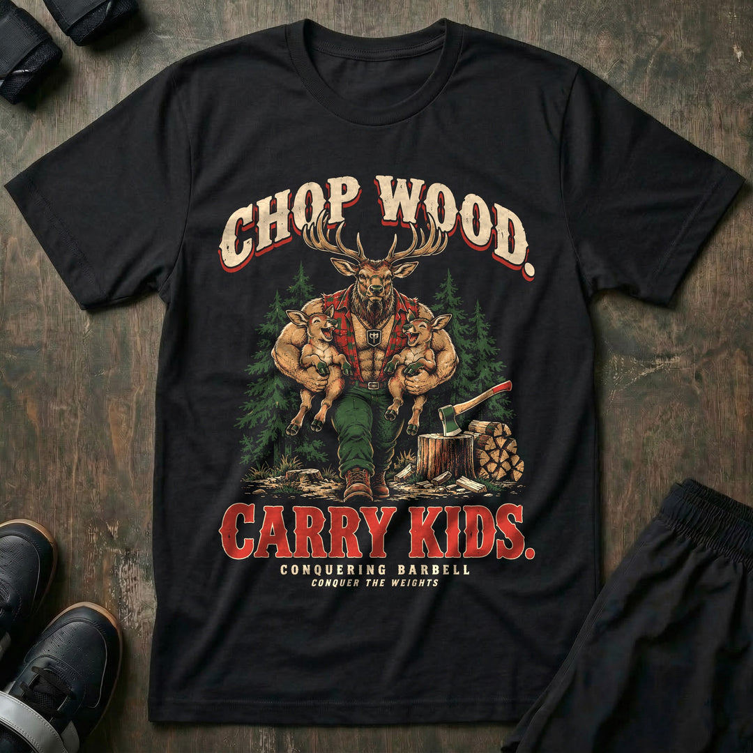 Chop Wood. Carry Kids - Tee front graphic in Black with a bull elk dad in a red flannel shirt carrying two laughing calves under his arms beside an axe in a stump and stacked firewood - Conquering Barbell
