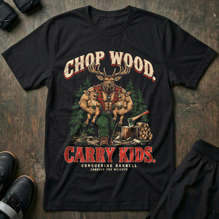 Chop Wood. Carry Kids - Tee front graphic in Black with a bull elk dad in a red flannel shirt carrying two laughing calves under his arms beside an axe in a stump and stacked firewood - Conquering Barbell