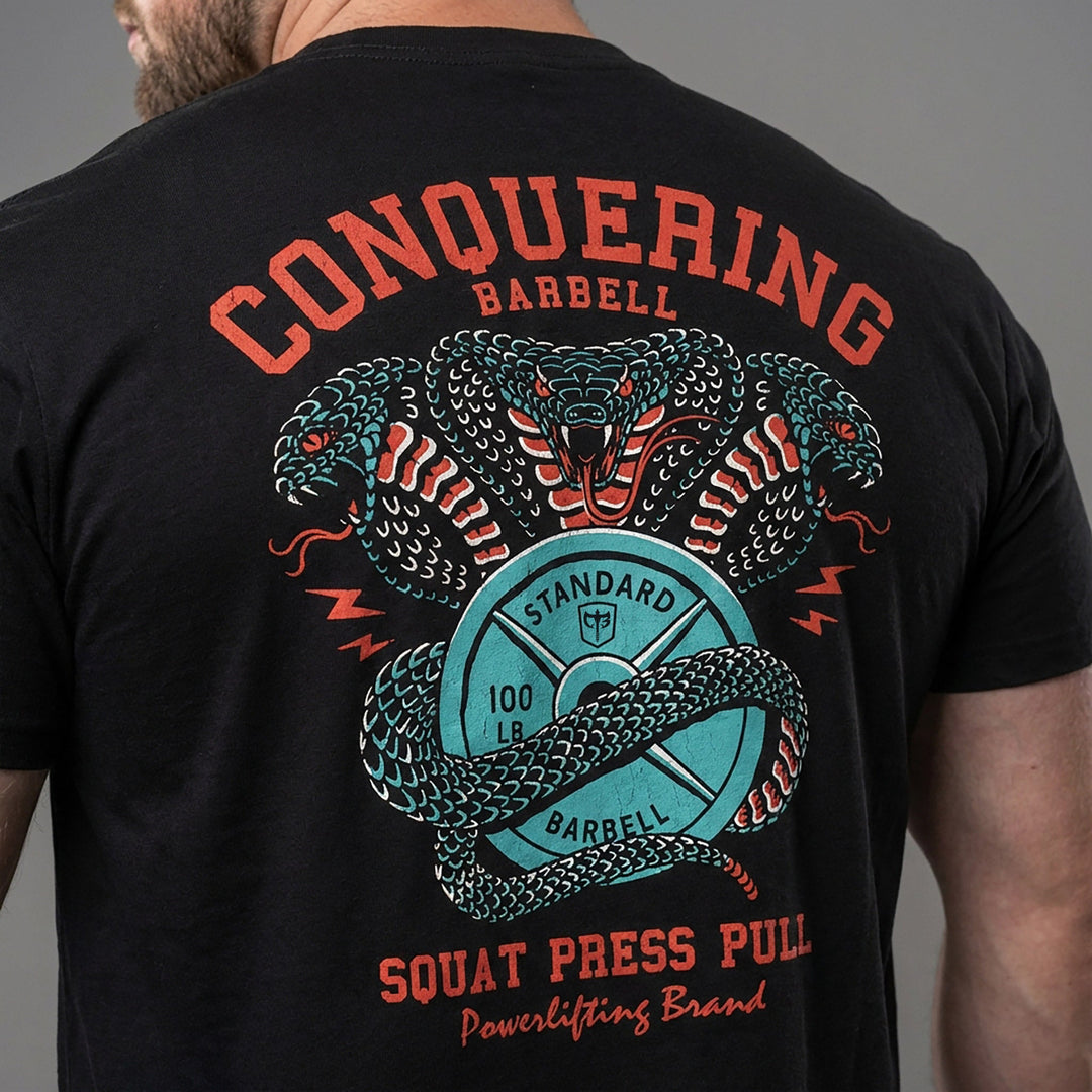 Cobras Squat Press Pull® tee in Black: twin teal cobras rearing over a barbell plate emblem