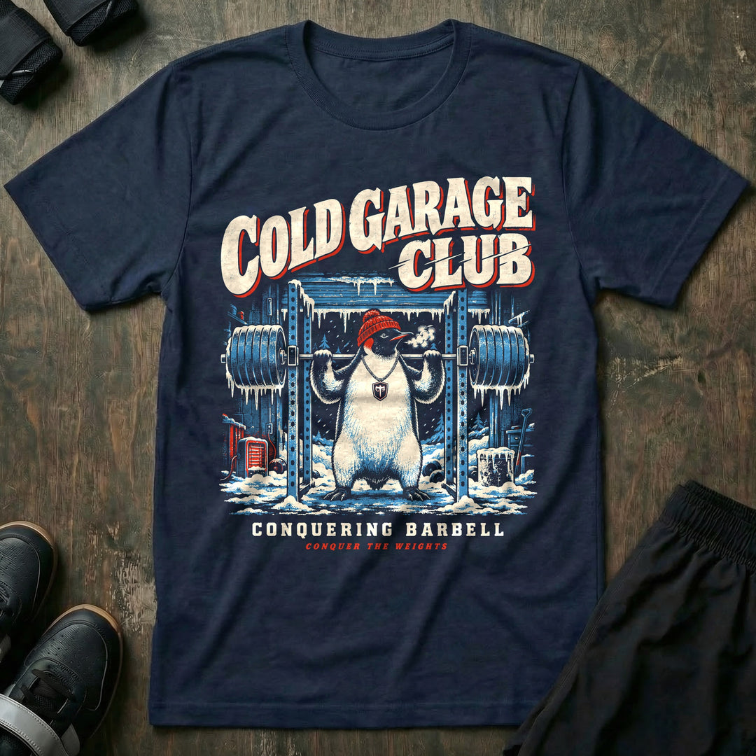 Cold Garage Club - Tee front graphic in Navy with a penguin in a red beanie squatting in a frozen garage gym - Conquering Barbell