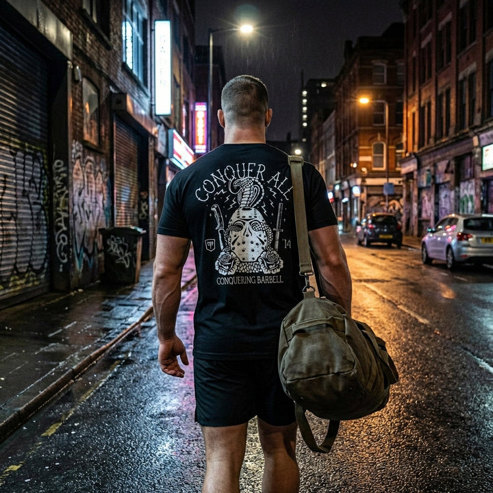 Conquer All Mask tee in Black: a distressed hockey mask wrapped in a coiling cobra