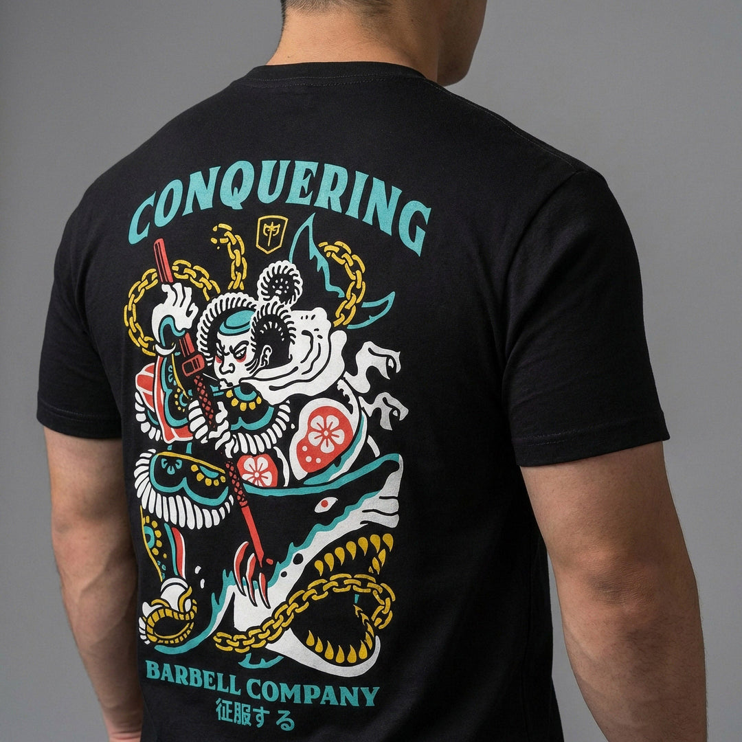 Conquer Bushido tee in Black: a tattoo-style samurai slaying a monstrous shark with chains and a katana in teal