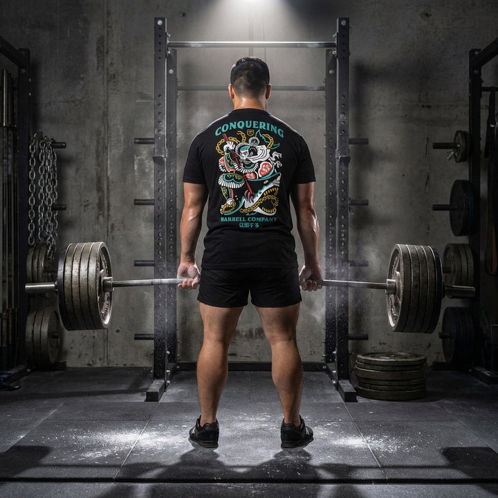 Conquer Bushido tee in Black: a tattoo-style samurai slaying a monstrous shark with chains and a katana in teal