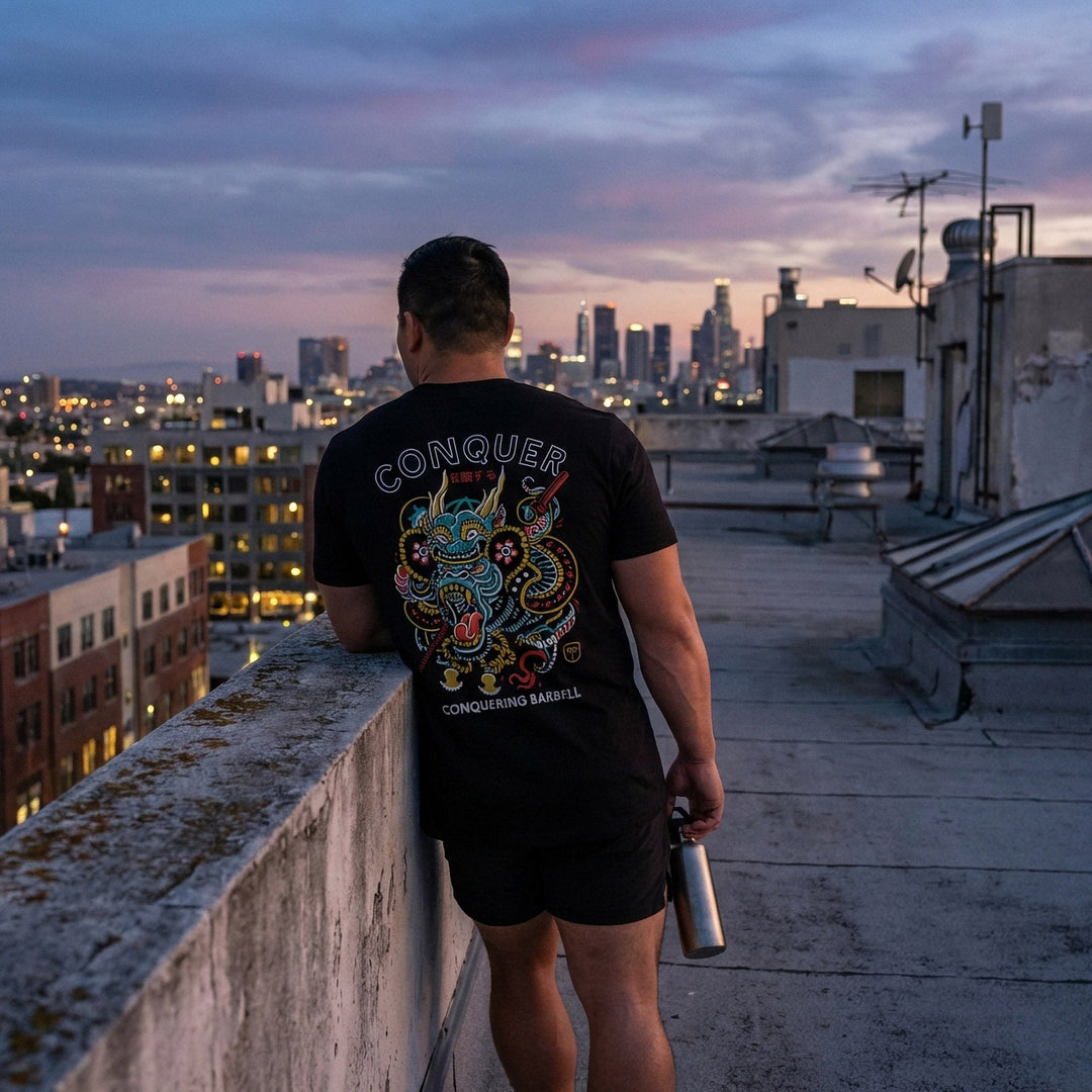 Conquer Gorilla tee in Black: an ornate tattoo-style gorilla wrapped in clouds and dragon scales in teal