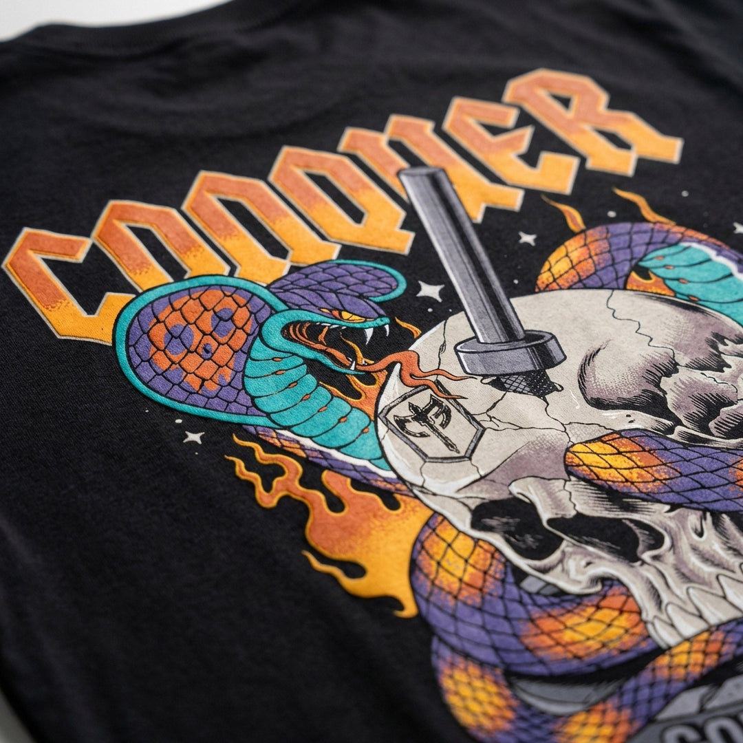 Conquer King Cobra tee in Black: a skull with twin king cobras coiled through it and a barbell piercing the center