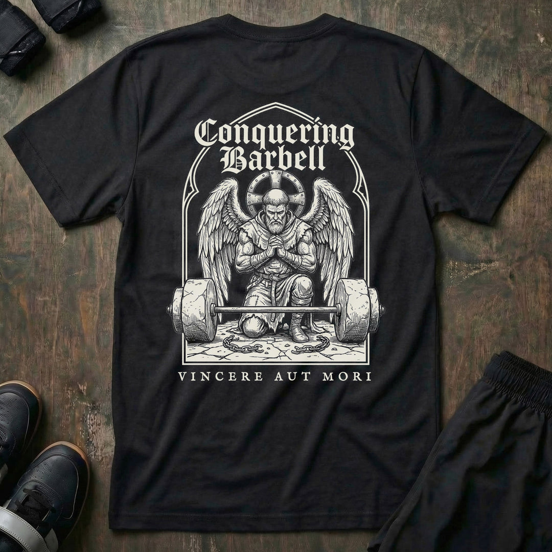 Conquer or Die Monk tee in Black: a winged warrior angel kneeling over a barbell inside a gothic archway