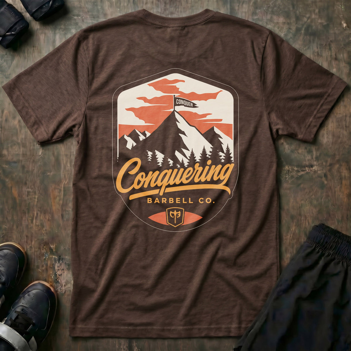 Conquer the Summit tee in Expresso: a bold outdoor badge with snow-capped peaks above a pine tree line