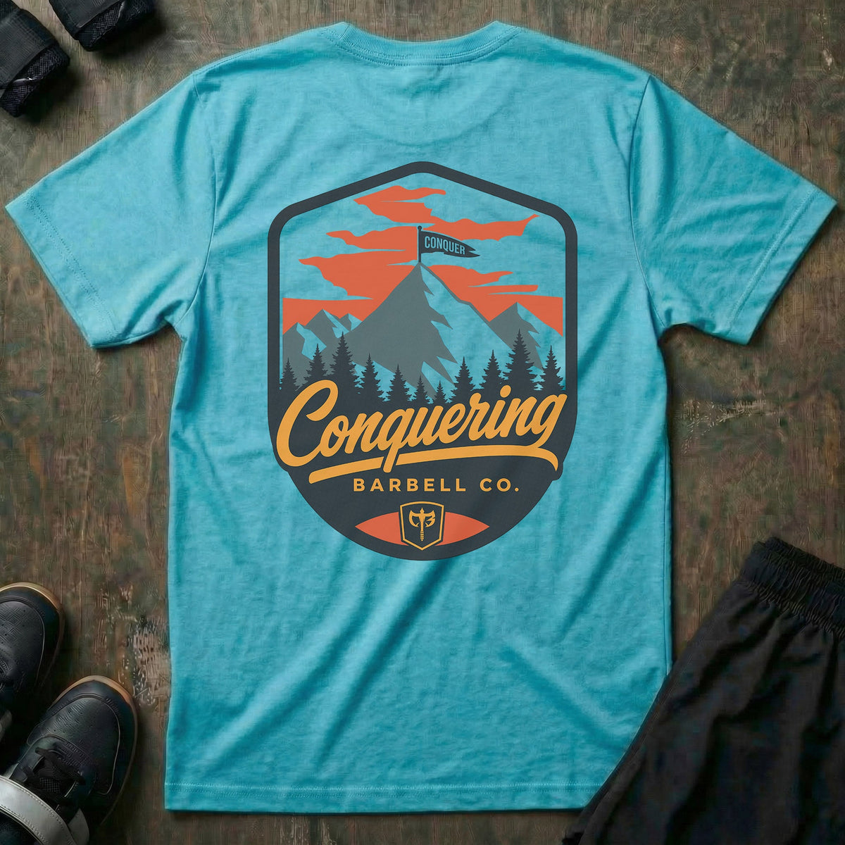 Conquer the Summit tee in Tahiti: a bold outdoor badge with snow-capped peaks above a pine tree line